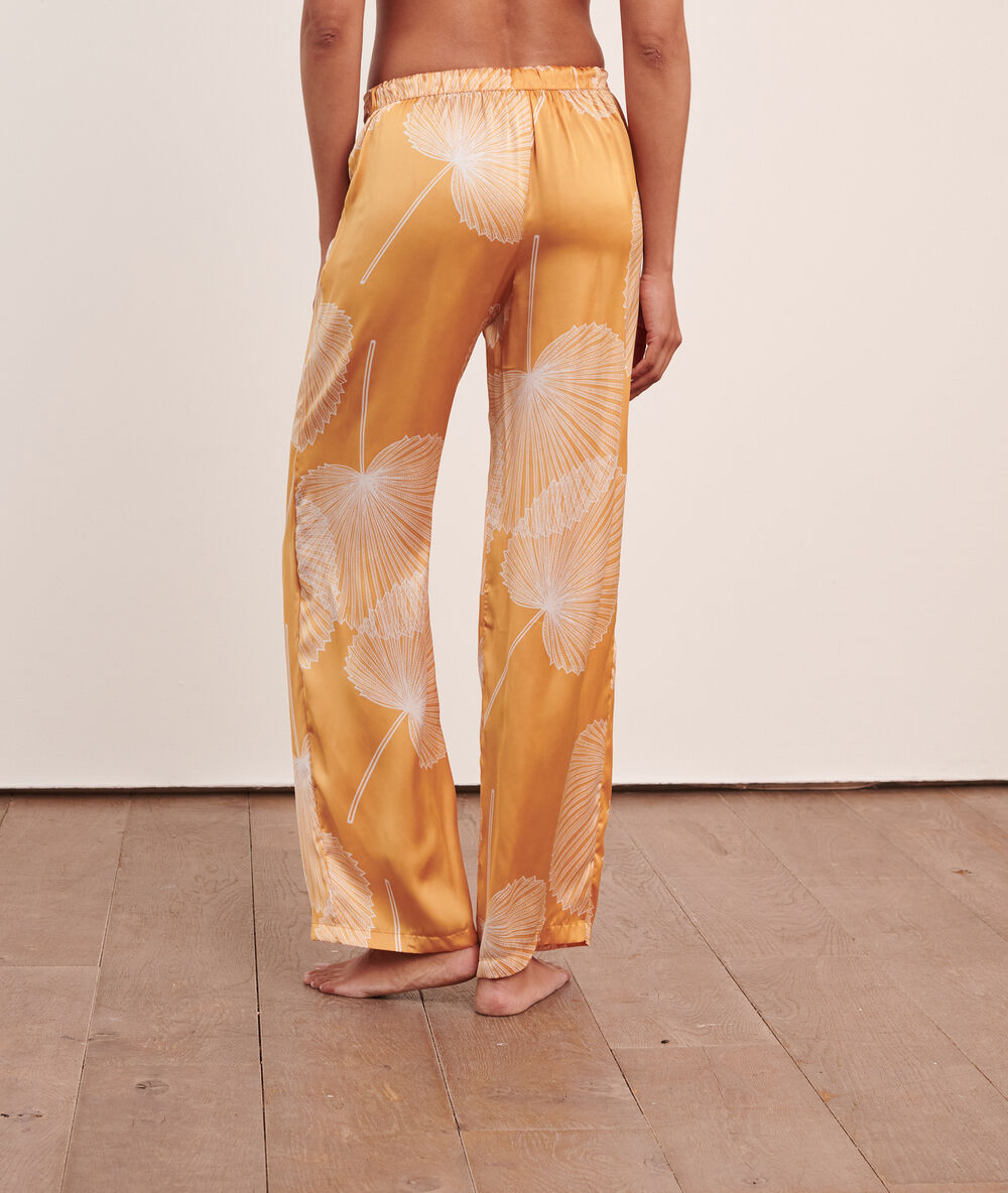 Pantalon satiné imprimé jaune vif.