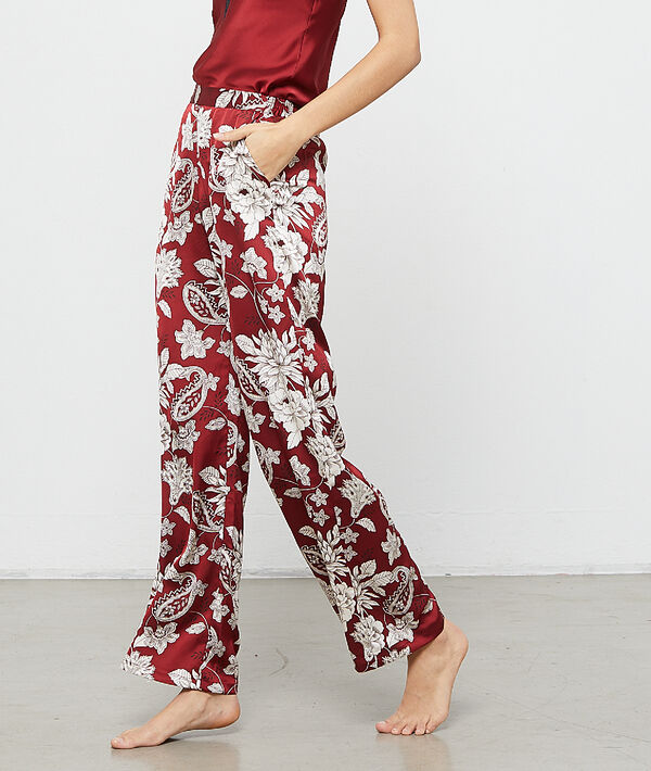 Pantalon satiné imprimé fleuri bordeaux.