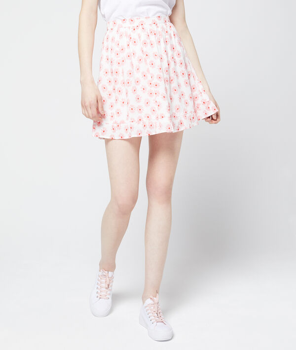 Jupe patineuse à imprimé fleuri rose pale.