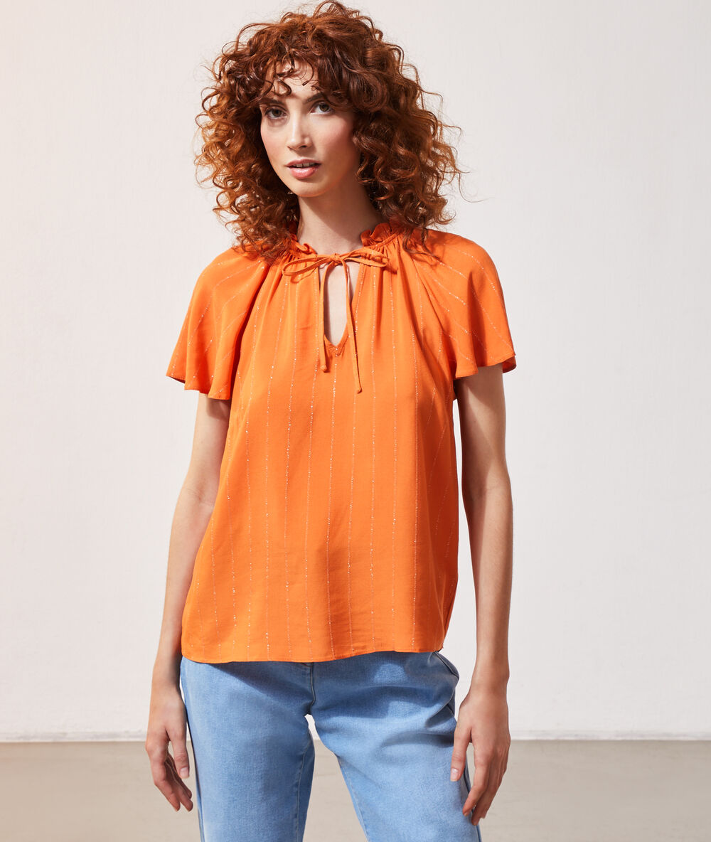 Blouse manches à volants orange.