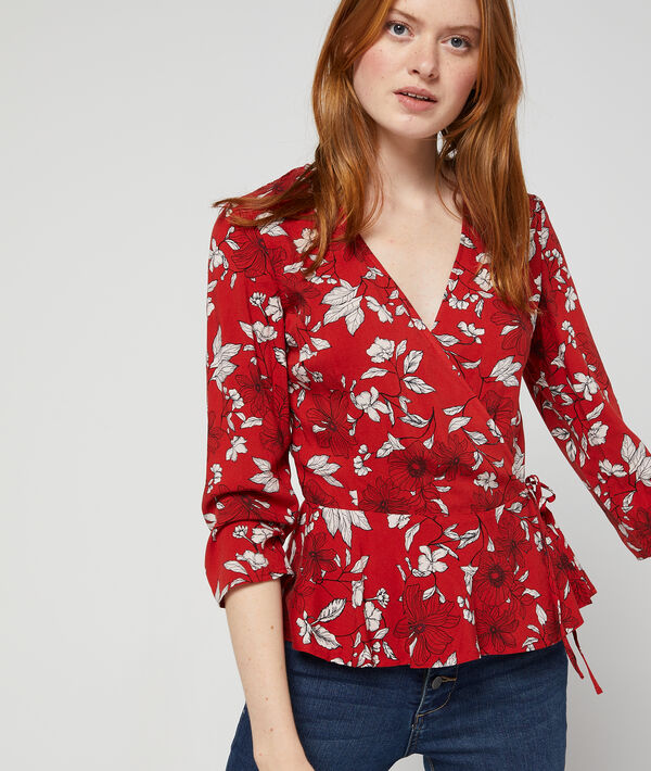 Blouse cache-coeur à imprimé floral rouge.