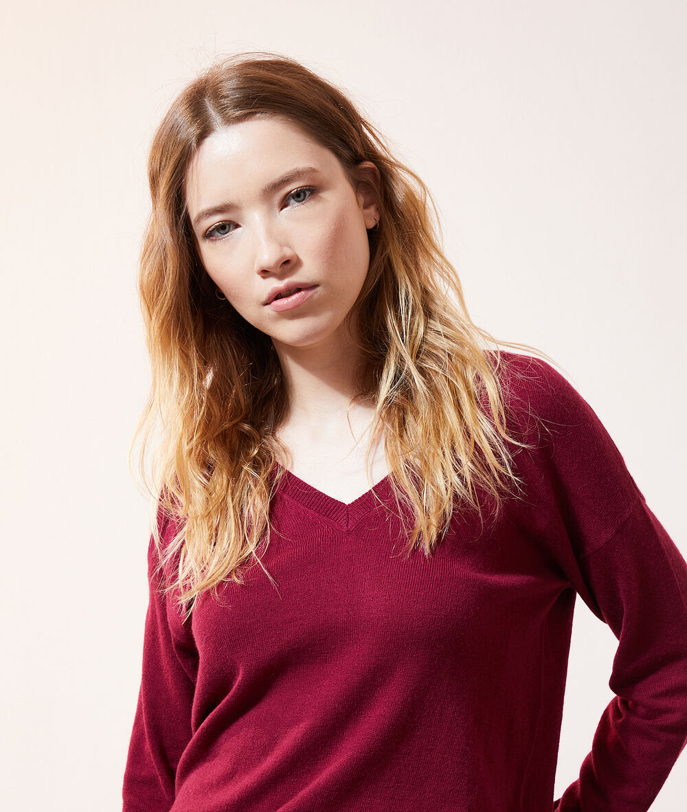 Pull col v asymétrique framboise.