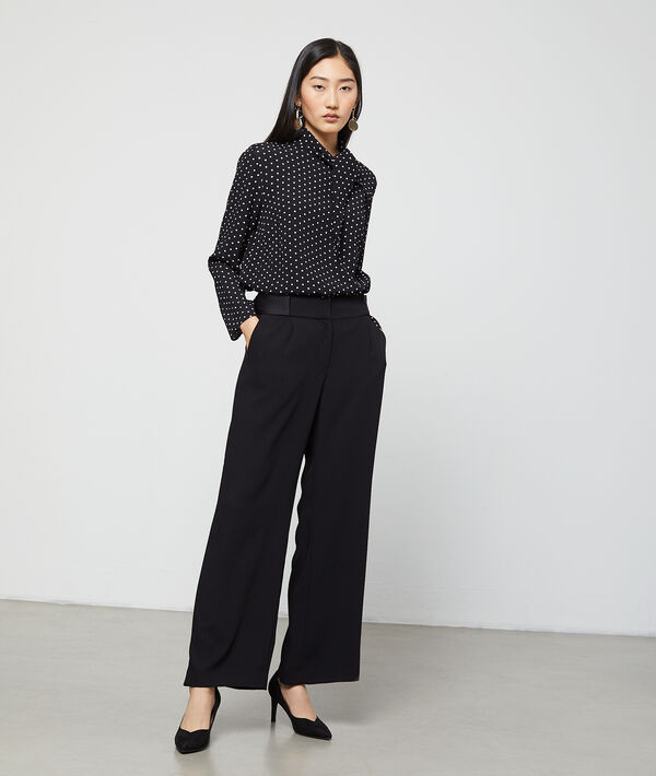 Blouse col noué à pois noir.
