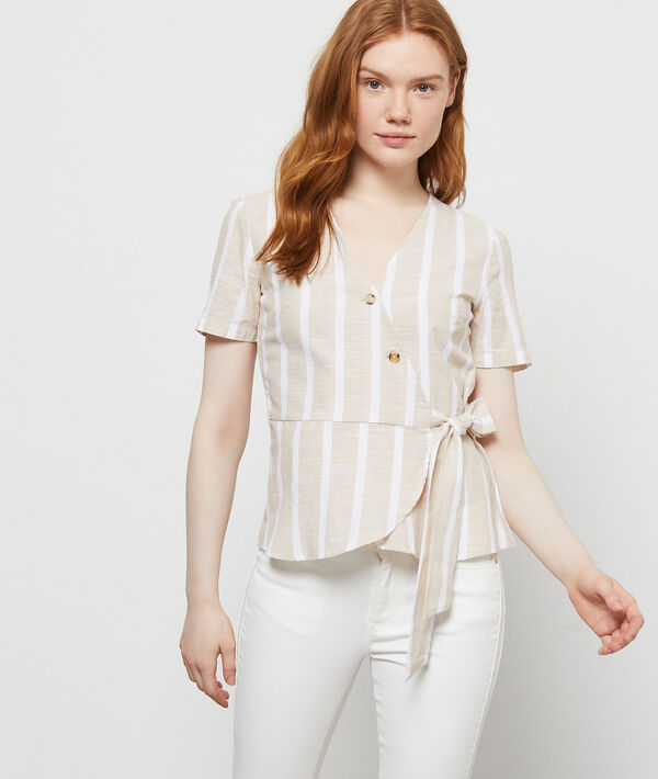 Blouse cache-coeur en coton beige.