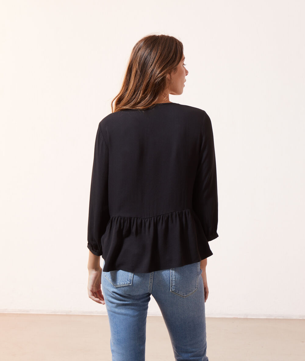 Blouse volantée à boutons noir.