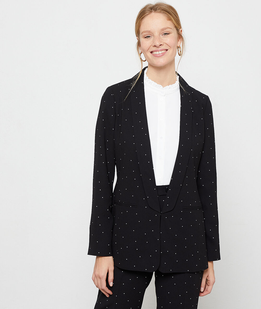 Veste de tailleur à pois noir.