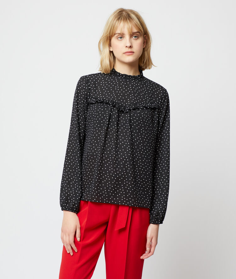 Blouse à pois noir.
