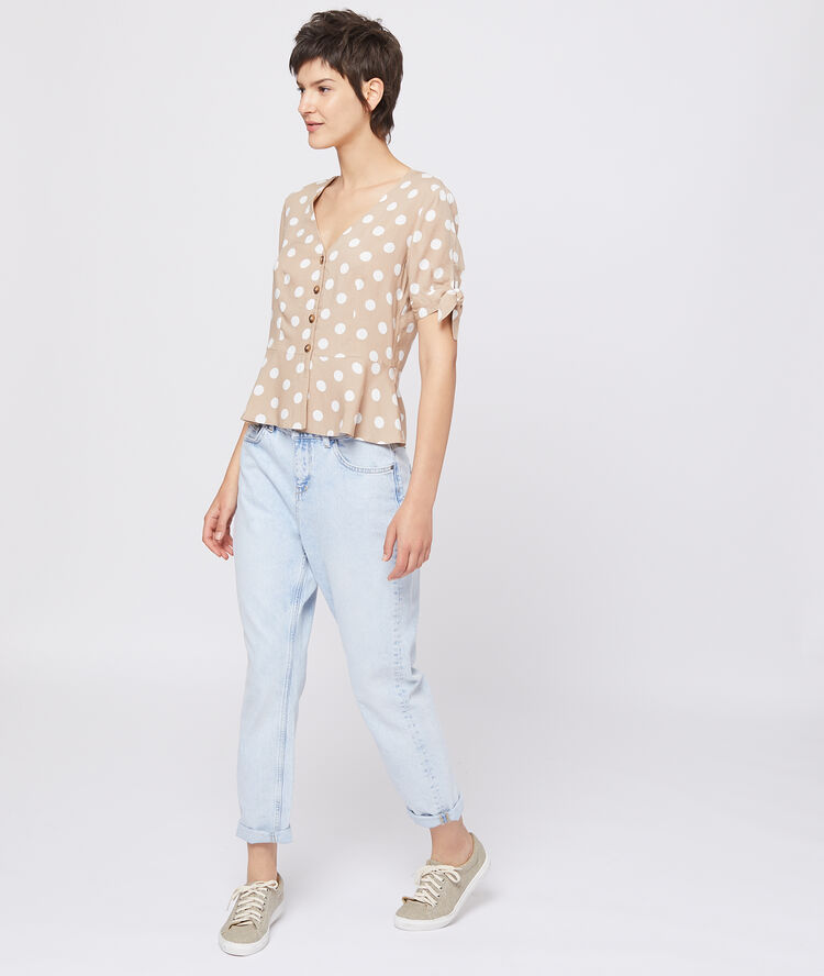 Blouse nouée à pois beige.