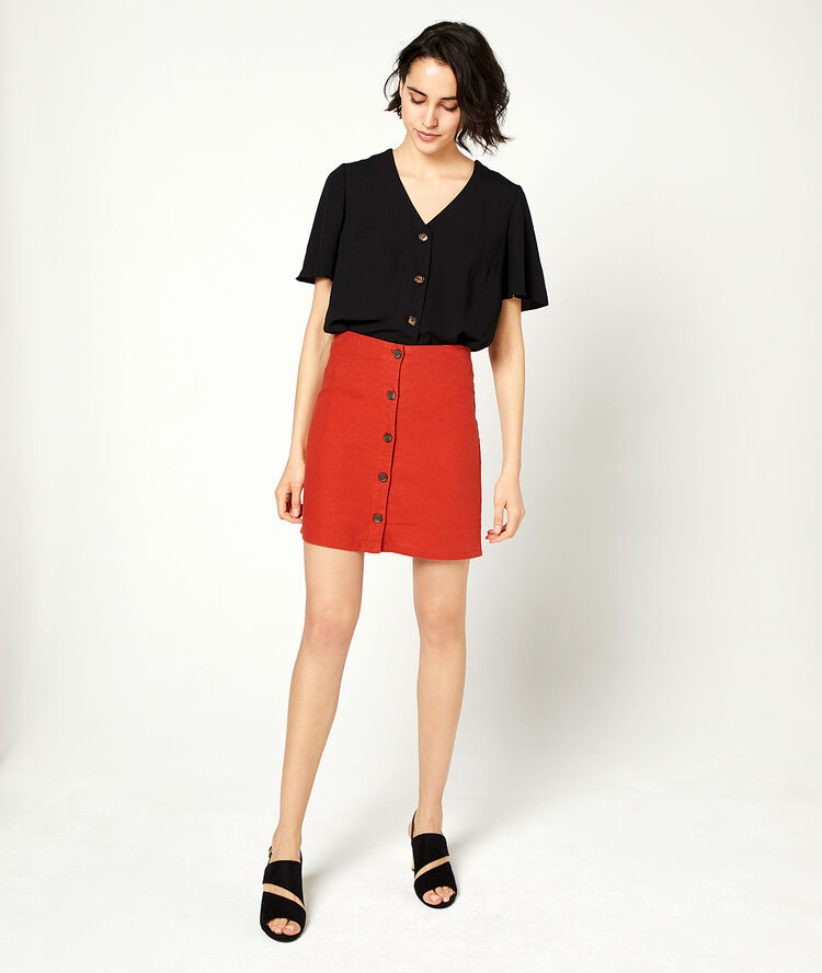 Blouse unie à boutons noir.